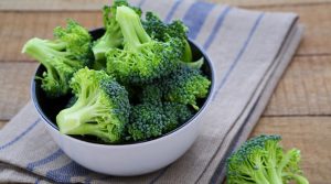 fresh broccoli in a bowl on a rustic table, food close up